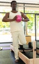 Portrait of sporty african american man with ball in a pilates class in gym Royalty Free Stock Photo