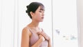 Portrait of a sporty Asian woman hands on chest and close her eyes, breathe in and breathe out, reunite with breath. Royalty Free Stock Photo