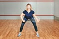 Portrait of a sporty blonde woman. young athletic girl holding squash tennis racquet Royalty Free Stock Photo