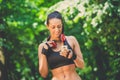 Portrait of sporty female using sport app on her mobile phone outdoors. Royalty Free Stock Photo