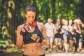 Portrait of sporty female using sport app on her mobile phone outdoors. Royalty Free Stock Photo