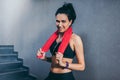 Portrait of sporty happy attractive brunette woman smiling with red towel on neck after workout in the gym. Sport, fitness, Royalty Free Stock Photo