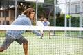 Sporty resolved man playing padel on open court