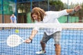 Sporty resolved man playing padel on open court