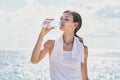 Sporty woman drinking mineral water after workout Royalty Free Stock Photo