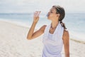 Sporty woman drinking mineral water after workout Royalty Free Stock Photo