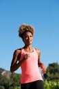 Sporty young african american woman running outdoors Royalty Free Stock Photo