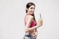 Portrait of sporty young caucasian woman holding plastic glass of orange juice. Royalty Free Stock Photo