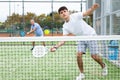 Sporty young guy playing padel on open court