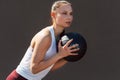 Portrait of a sporty young woman doing exercises with a medicine ball outdoors on a sunny day. Fitness female exercising fitness Royalty Free Stock Photo