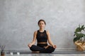 Portrait of sporty young woman doing exercises on yoga lesson at home. Beautiful girl practicing easy yoga pose Royalty Free Stock Photo