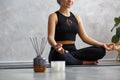 Portrait of sporty young woman doing exercises on yoga lesson at home. Beautiful girl practicing easy yoga pose Royalty Free Stock Photo