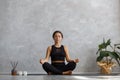 Portrait of sporty young woman doing exercises on yoga lesson at home. Beautiful girl practicing easy yoga pose Royalty Free Stock Photo