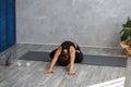 Portrait of sporty young woman doing exercises on yoga lesson at home. Beautiful girl practicing lotus yoga pose Royalty Free Stock Photo