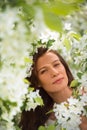 Portrait of spring brunette girl standing outdoor in blooming tr Royalty Free Stock Photo