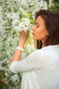 Portrait of spring brunette girl standing outdoor in blooming tr Royalty Free Stock Photo