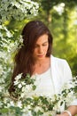 Portrait of spring brunette girl standing outdoor in blooming tr Royalty Free Stock Photo