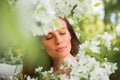 Portrait of spring brunette girl standing outdoor in blooming tr Royalty Free Stock Photo