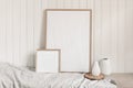 Portrait and square empty wooden frame mockups with linen cloth and modern ceramic vases. White beadboard wainscot wall