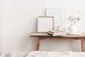 Portrait and square wooden picture frames mockups. Vintage bench, table with modern ceramic vase, bunny tail dry grass