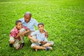 Portrait of squatted african father with two