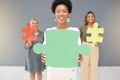 Portrait, staff and black woman with puzzle, team building and planning for project in workplace. Face, African American