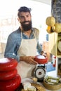 Portrait of staff weighing gouda cheese at counter Royalty Free Stock Photo