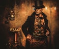 Portrait of steampunk man with various mechanical devices on vintage steampunk background Royalty Free Stock Photo