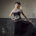 Portrait of a steampunk woman over grunge background. Beautiful lady in a Victorian style