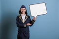 Portrait of stewardess holding white blank speech bubble Royalty Free Stock Photo