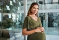 Portrait, stomach and business with a pregnant woman in her office at the start of her maternity leave from work