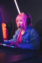 Portrait Streamer young woman professional gamer playing online games computer, neon color, vertical