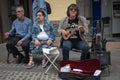 Portrait of street life in Teror, a middle-aged musician with sunglasses playing the ukulele