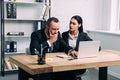 portrait of stressed business people in suits at workplace with laptop Royalty Free Stock Photo