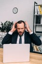 portrait of stressed businessman at workplace with laptop Royalty Free Stock Photo