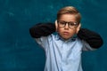 Stressed child wearing eyeglasses and shirt