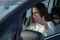 Portrait of stressed and confused woman panics in a dangerous situation on the road while driving. Horizontal image