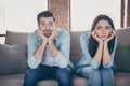 Portrait of stressed frustrated couple man woman sit divan have nothing to do on covid-19 quarantine feel bored wear Royalty Free Stock Photo