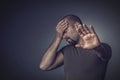 Portrait of a stressed man with his eyes closed and his hand on his forehead