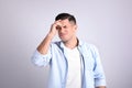 Portrait of stressed man on light background