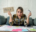 Portrait of stressed and overwhelmed young woman with too much credit card debts