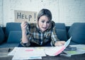 Portrait of stressed and overwhelmed young woman trying to manage home finances paying bills Royalty Free Stock Photo