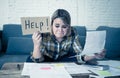 Portrait of stressed and overwhelmed young woman trying to manage home finances paying bills Royalty Free Stock Photo