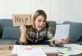 Portrait of stressed and overwhelmed young woman trying to manage home finances paying bills Royalty Free Stock Photo