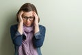 Portrait stressed sad middle aged woman. Background green wall, copy space.