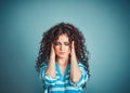 Portrait stressed sad young woman isolated blue background. City stress concept