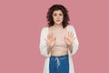 Portrait of stressed scared beautiful brunette young woman with curly hairstyle in casual style standing and looking at camera Royalty Free Stock Photo