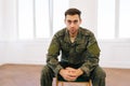 Portrait of stressed soldier male in camouflage uniform sitting in circle during PTSD group therapy session looking at Royalty Free Stock Photo