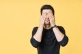 Portrait of stressed tired man closed eyes by two hands over yellow background Royalty Free Stock Photo