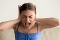 Depressed woman closing ears and screaming Royalty Free Stock Photo